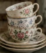 Stacked floral china teacups on saucers